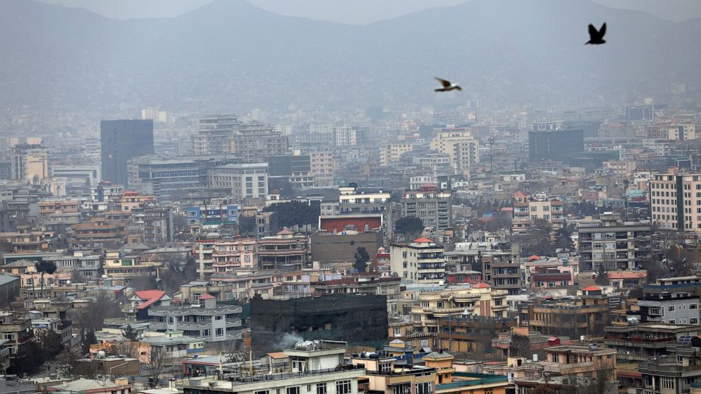 FILE - In this Feb. 1, 2021 file photo, birds flyover the city of Kabul, Afghanistan. The United States wasted billions of dollars in war-torn Afghanistan on buildings and vehicles that were either abandoned or destroyed, according to a report releas