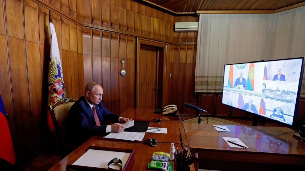 Russian President Vladimir Putin attends a meeting of the Supreme State Council of the Union State of Russia and Belarus via videoconference from Sevastopol, Crimea, Thursday, Nov. 4, 2021. Belarusian President Alexander Lukashenko in in the left cor