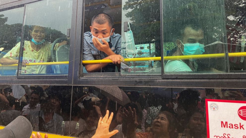 A man looks out from a bus window as people look for their family members and relatives on a bus carrying prisoners who released from Insein Prison Thursday, Nov. 17, 2022, in Yangon, 2022, in Yangon, Myanmar. The country's military-controlled govern