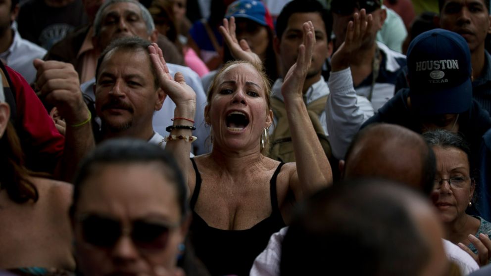 Opposition members cheer for Juan Guaido, President of Venezuelan National Assembly, during a speech in Caracas, Venezuela, Friday, Jan. 11, 2019. The head of Venezuela's opposition-run congress says that with the nation's backing he's ready to take 