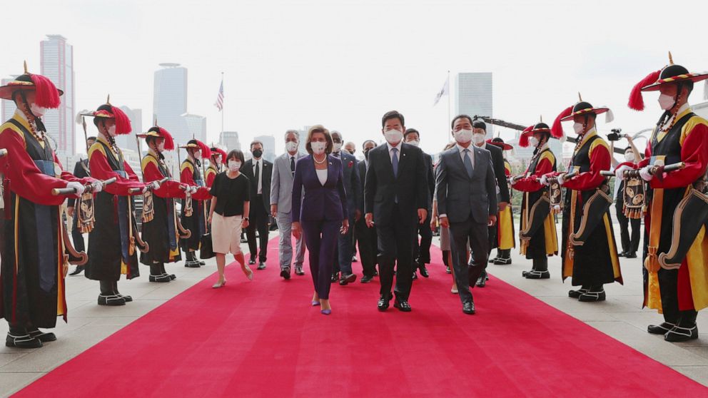 U.S. House Speaker Nancy Pelosi, center left, and South Korean National Assembly Speaker Kim Jin Pyo, center right, inspect an honor guard upon her arrival at the National Assembly in Seoul, South Korea, Thursday, Aug. 4, 2022. (Lee Jung-hoon/Yonhap 