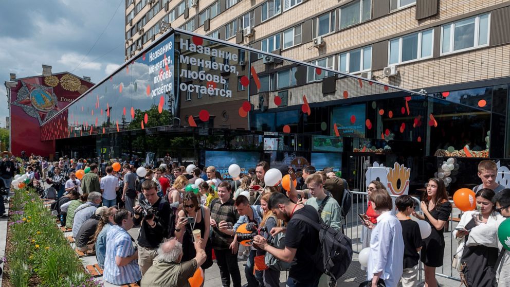 People lineup to visit a newly opened fast food restaurant in a former McDonald's outlet in Bolshaya Bronnaya Street in Moscow, Russia, Sunday, June 12, 2022. The sign reads 'The Name Changes, Love Remains'. The first of former McDonald's restaurants