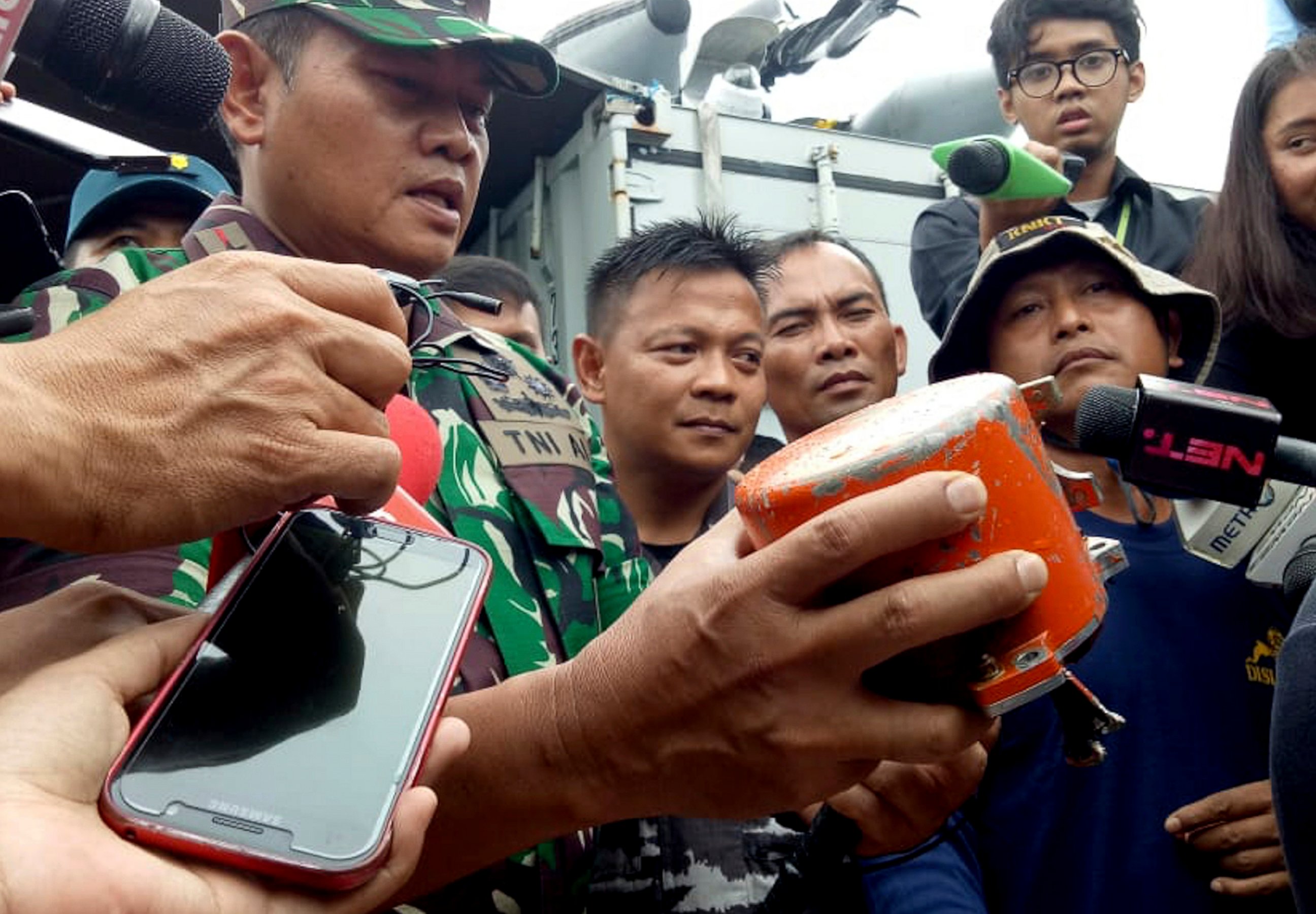 Indonesian Navy Commander Rear Admiral Yudo Margin shows the recovered cockpit voice recorder of Lion Air flight 610 that crashed into the sea in October during a press conference on board of the navy ship KRI Spica in the waters off Tanjung Karawang