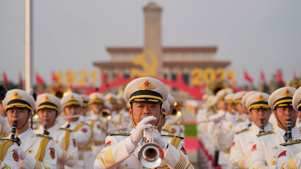 FILE - In this July 1, 2021, file photo, a military band rehearses for a ceremony to mark the 100th anniversary of the founding of the ruling Chinese Communist Party at Tiananmen Gate in Beijing. Chinese fighter jets, anti-submarine aircraft and comb