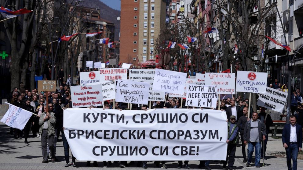 Kosovo Serbs with antigovernment banners protest to pressure the government into allowing them to vote in neighboring Serbia's April 3 election, in Mitrovica, Kosovo, Friday, March 25, 2022. The United States, France, Germany, Italy and the U.K. expr