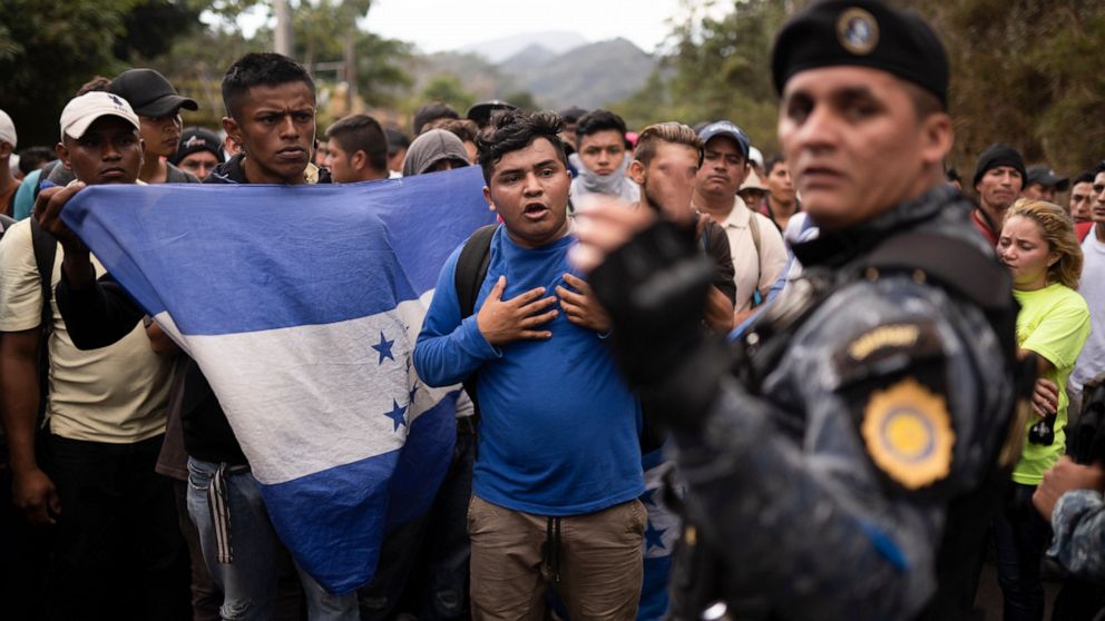 FILE - In this Jan. 16, 2020 file photo, Honduran migrants hoping to reach the U.S. border are stopped by Guatemalan police near Agua Caliente, Guatemala, on the border with Honduras. The reasons Hondurans continue to flee their country have been wel