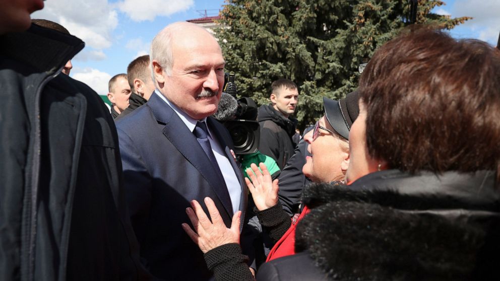 Belarus President Alexander Lukashenko speaks with local residents in the town of Bragin, some 360 km ( 225 miles) south-east of Minsk, Belarus, Monday, April 26, 2021. Alexander Lukashenko took part in a requiem rally on the occasion of the 35th ann