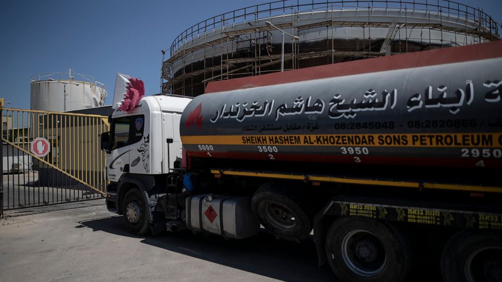 FILE - A fuel truck with a Qatari flag enters the Nusseirat power plant, in the central Gaza Strip, Monday, June 28, 2021. Gaza's Hamas rulers have reached an agreement by which Qatar will resume subsidizing the salaries of public employees by sendin