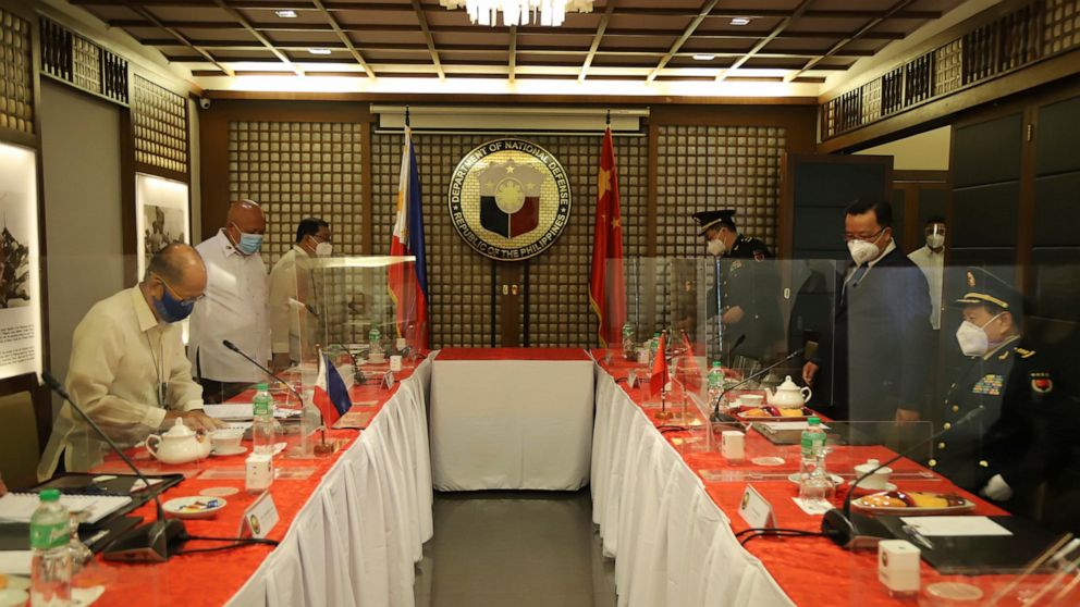 In this handout photo provided by the Department of National Defense Public Affairs Office (PAO), Philippine Defense Secretary Delfin N. Lorenzana, left, prepares to sit for a bilateral meeting with his Chinese counterpart General Wei Fenghe, right, 