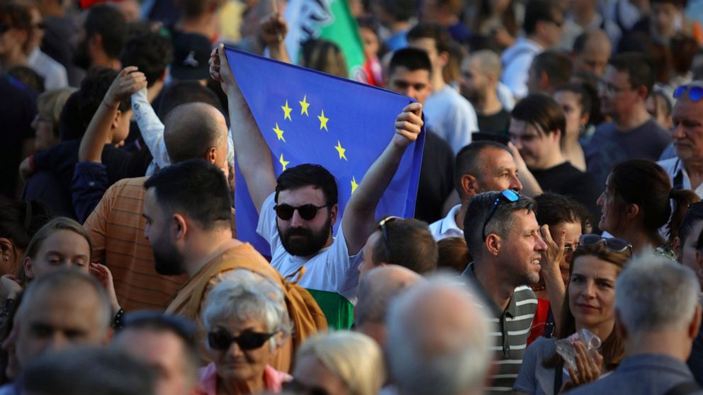 A pro-government protester holds EU flag during demonstration in support of incumbent Bulgarian government near the Bulgarian Parliament building in Sofia, Tuesday, June 21, 2022. Bulgarian lawmakers have started debating a no-confidence motion again