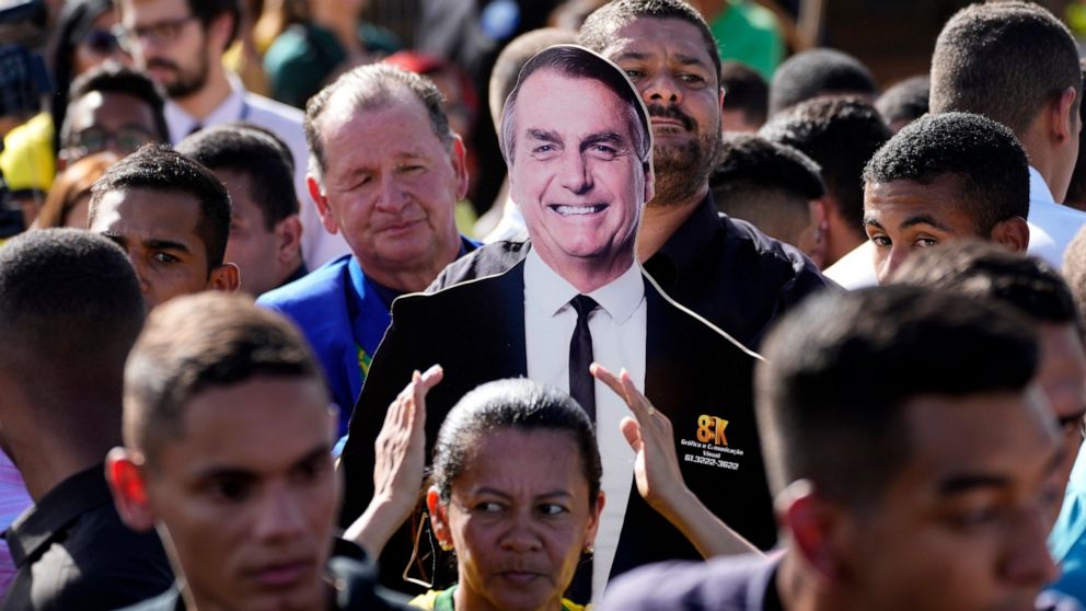 Supporters carry a life-size image of Brazil's President Jair Bolsonaro during a campaign rally in the rural workers' settlement Nova Jerusalem, or New Jerusalem, in Brasilia, Brazil, Monday, Oct. 24, 2022. Bolsonaro is running for reelection in the 