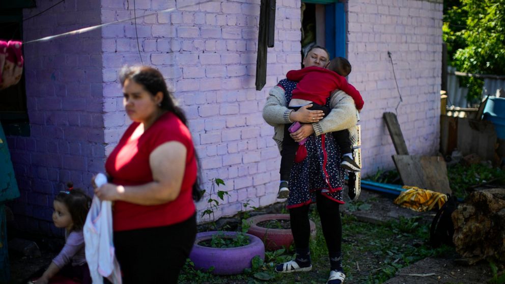 Local resident gather outside their heavily damaged house after a Russian strike in Pokrovsk, eastern Ukraine, Wednesday, May 25, 2022. Two rockets struck the eastern Ukrainian town of Pokrovsk, in the Donetsk region early Wednesday morning, causing 