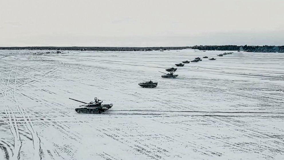 FILE - In this photo taken from video and released by the Russian Defense Ministry Press Service on Friday, Feb. 4, 2022, tanks and armored vehicles move during the Belarusian and Russian joint military drills at Brestsky firing range, Belarus. With 