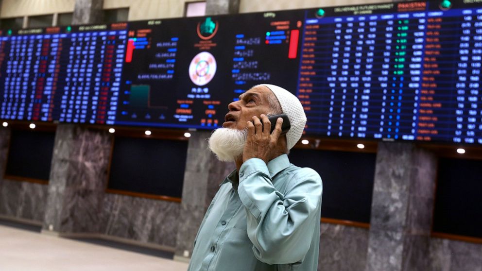 An investor monitors Index on the big screen at at the Pakistan Stock Exchange (PSE), in Karachi, Pakistan, Friday, June 24, 2022. Pakistan's stock market suddenly fell by three percent on Friday, shortly after the government of recently elected Prim
