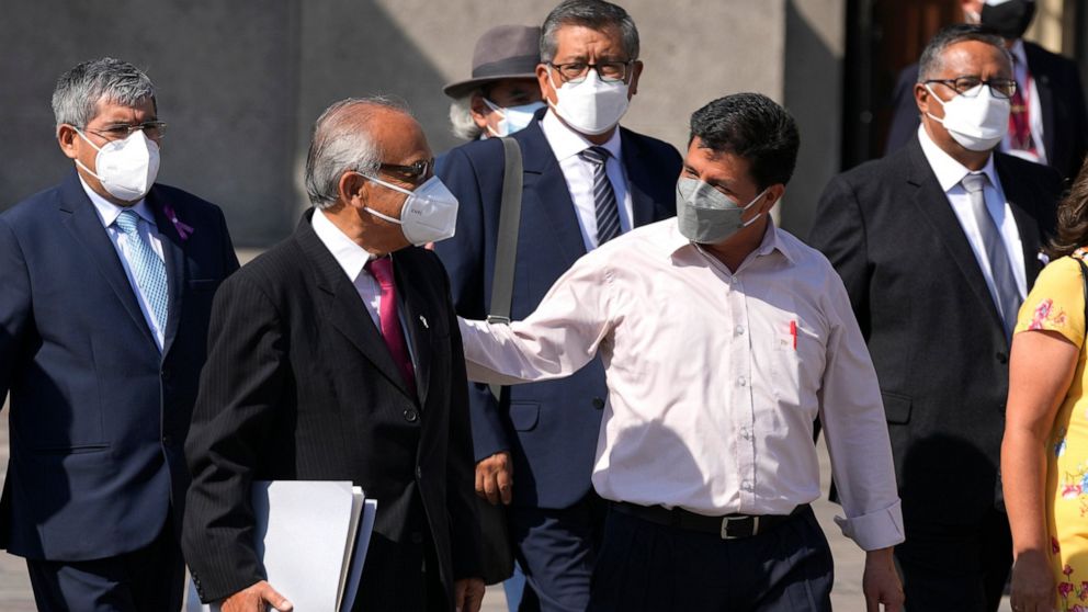FILE - Peru's President Pedro Castillo, front right, walks alongside Prime Minister Anibal Torres and members of his cabinet outside the government palace in Lima, Peru, March 8, 2022. On Aug. 3, 2022 Torres announced that he presented his resignatio