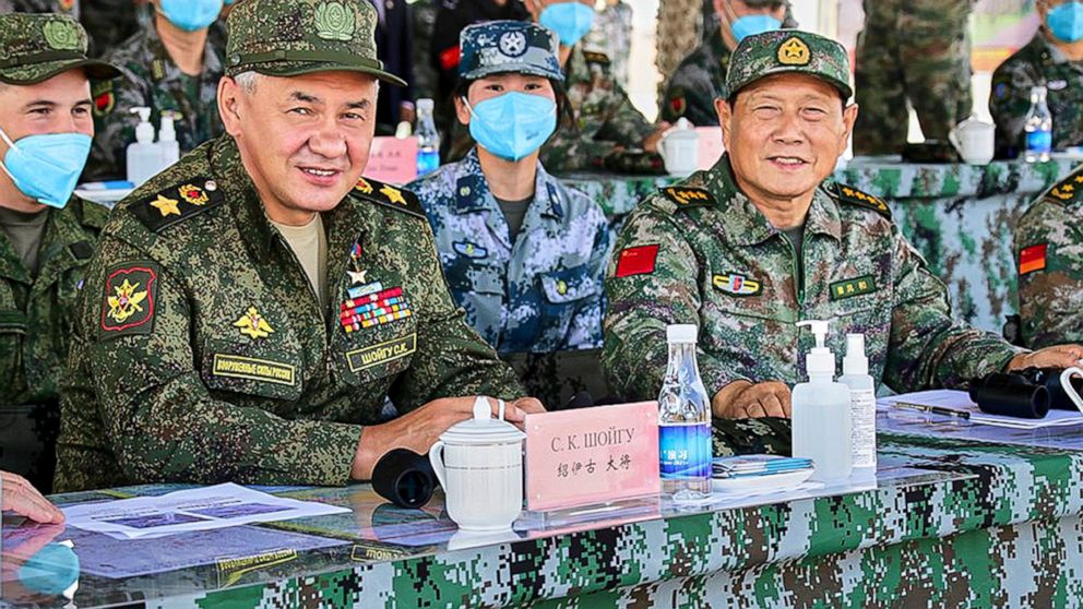 In this handout photo released by Russian Defense Ministry Press Service, Russian Defense Minister Sergei Shoigu and Chinese Defense Minister Wei Fenghe watch a joint military exercise by Russia and China held in the Ningxia Hui Autonomous Region in 