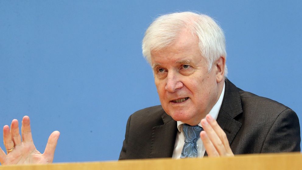 Horst Seehofer, German Minister of the Interior, attends a news conference about a report on extremism in Germany in Berlin, Germany, Tuesday, Oct. 6, 2020 (Wolfgang Kumm/Pool via AP)