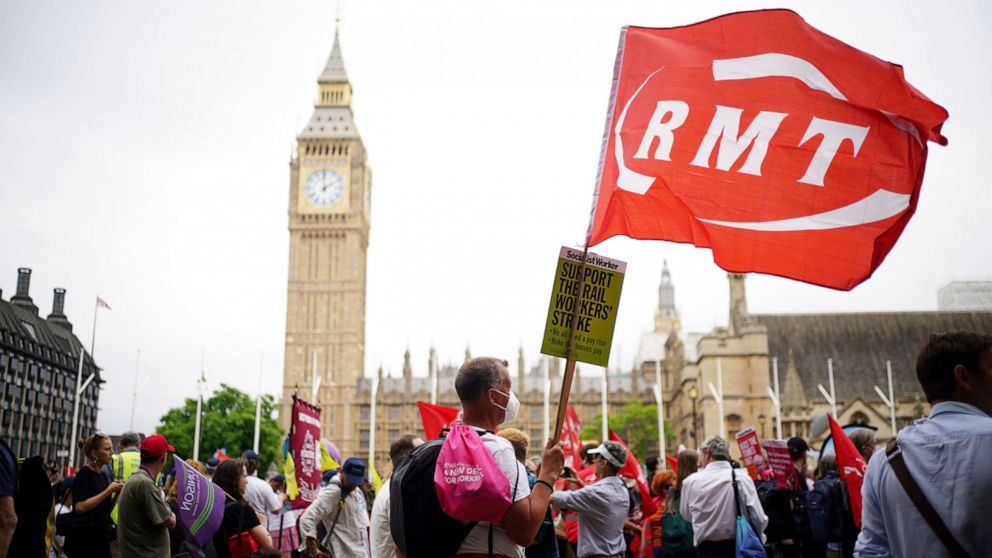 People from differents unions and members of the public hold up placards as they take part in a TUC national demonstration to demand action on the cost of living, a new deal for working people and a pay rise for all workers, in London, Saturday June 