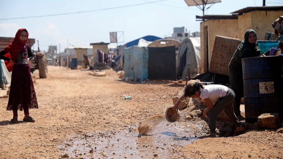 FILE - This Sunday, April 19, 2020 file photo, shows a large refugee camp on the Syrian side of the border with Turkey, near the town of Atma, in Idlib province, Syria. The head of the U.N. food agency warned of starvation and another wave of mass mi