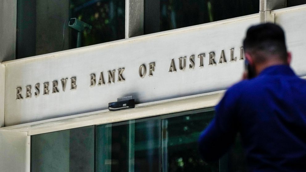 FILE - A man walks past the Reserve Bank of Australia building in Sydney, Australia, Oct. 7, 2021. Australia’s central bank on Tuesday, May 3, 2022, lifted its benchmark interest rate for the first time in more than 11 years. The cash rate rose from 