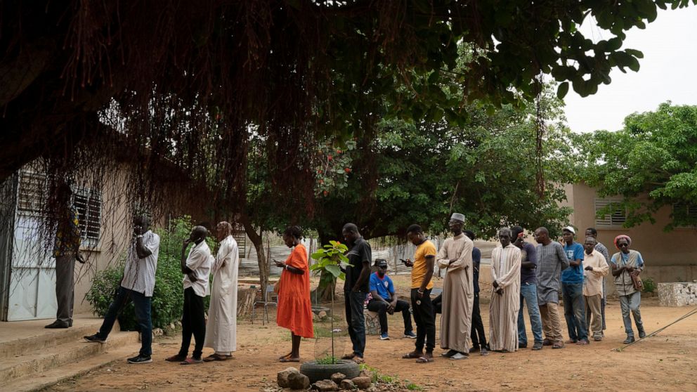 People line up to cast their ballot for legislative elections in Dakar, Senegal, Sunday, July 31, 2022. The West African nation is holding legislative elections, a vital test for opposition parties trying to minimize ruling party influence before 202