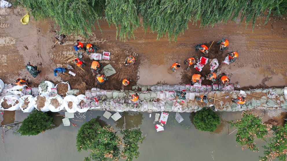 Flooding sends bus into river in China; 120,000 evacuated