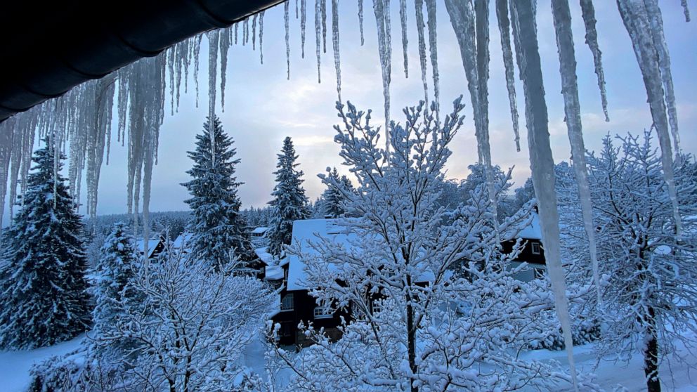 Eiffel Tower needs torch for ice while snow covers Europe