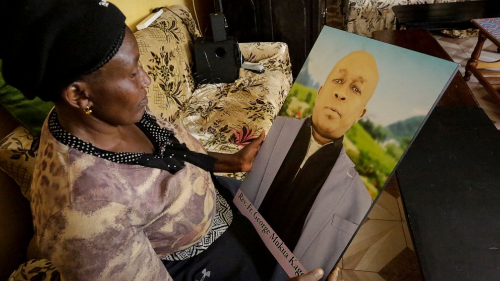 In this photo taken Thursday, Feb. 27, 2020, Ruth Kageche, whose brother Rev. George Mukua Kageche, a priest based in Italy, perished on the ill-fated Ethiopian Airlines flight ET302 in 2019, holds a portrait him during an interview with The Associat