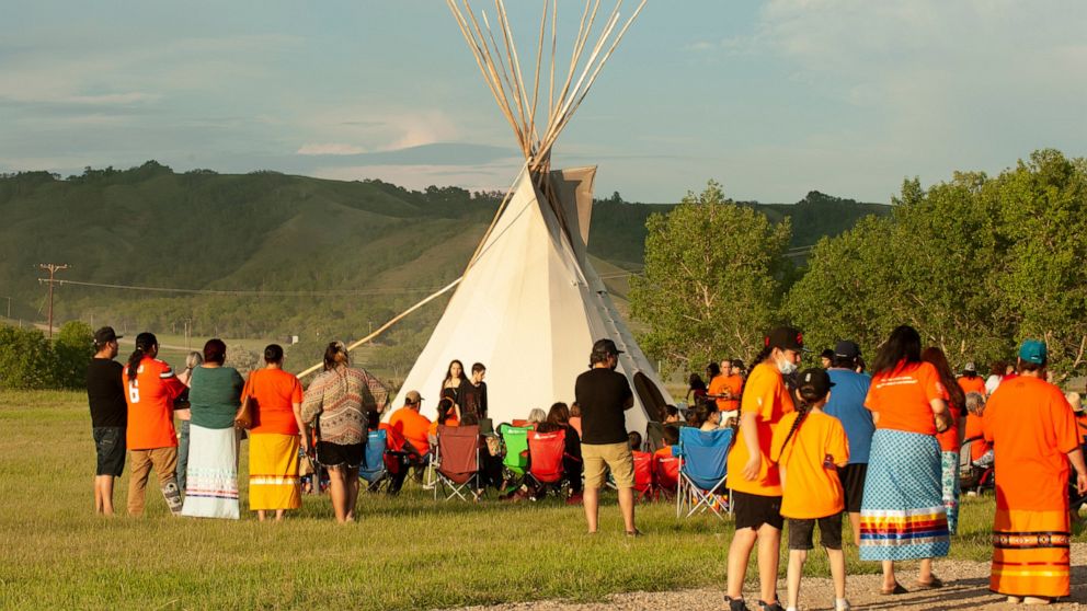A vigil takes place where ground-penetrating radar recorded hits of what are believed to be 751 unmarked graves near the grounds of the former Marieval Indian Residential School on the Cowessess First Nation, Saskatchewan, Saturday, June 26, 2021. (M