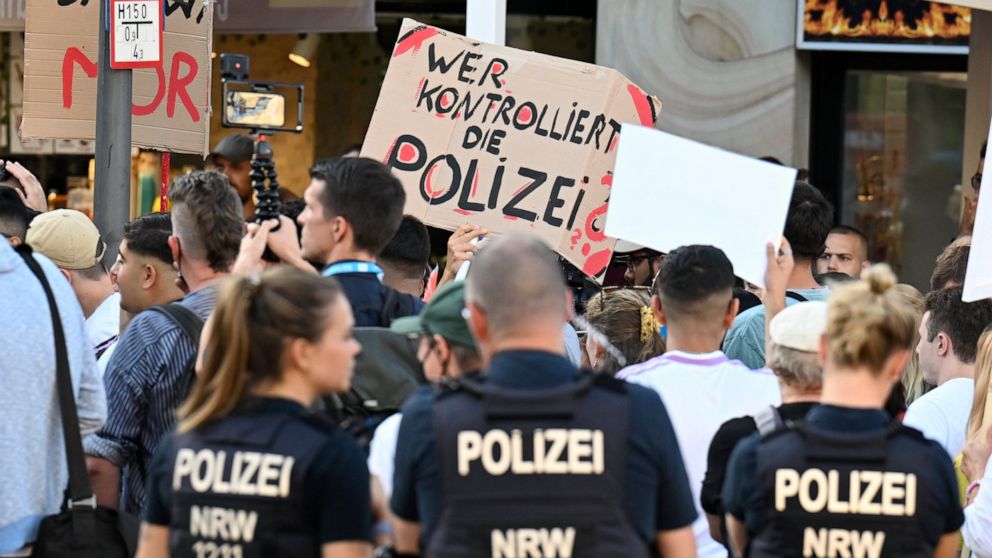 Two days after the fatal police shooting of a 16-year-old, several hundred demonstrators protest against the death of the boy in front of the North Police Station in Dortmund, Germany, Wednesday, Aug. 10, 2022. A German top security official vowed Th