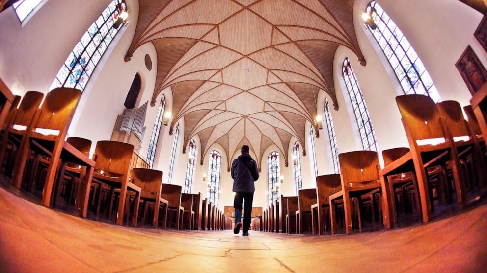FILE - In this Oct. 11, 2016 file photo a man walks in the St.Katharinen church in Frankfurt, Germany. A study predicts that Germany’s two main Christian churches will lose millions of members over the coming decades and have to tighten their financi