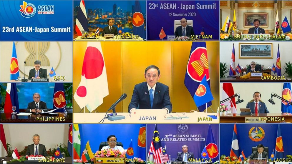 A screen shows Japanese Prime Minister Yoshihide Suga, center, speaking during a virtual summit with ASEAN leaders in Hanoi, Vietnam on Thursday, Nov. 12, 2020. (VNA via AP)