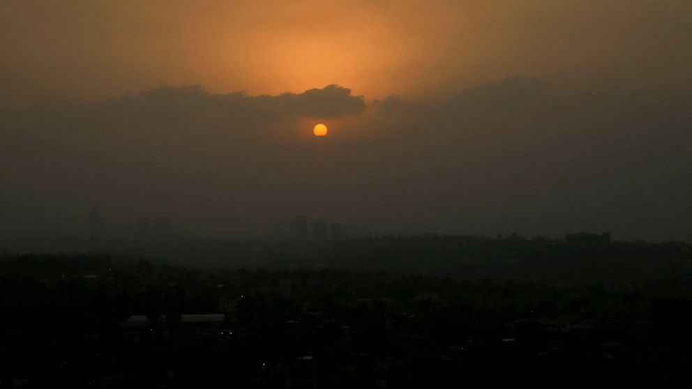 The sun sets amid a dust storm in Mexico City, Sunday, March. 28, 2021. (AP Photo/Marco Ugarte)