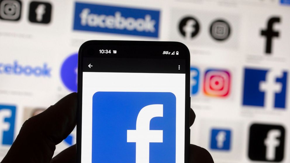 FILE - The Facebook logo is seen on a cell phone, on Oct. 14, 2022, in Boston. Facebook parent Meta said Tuesday Oct. 18, 2022 it will sell off Giphy after running out of options to thwart a ruling by U.K. regulators, who again found that the deal to