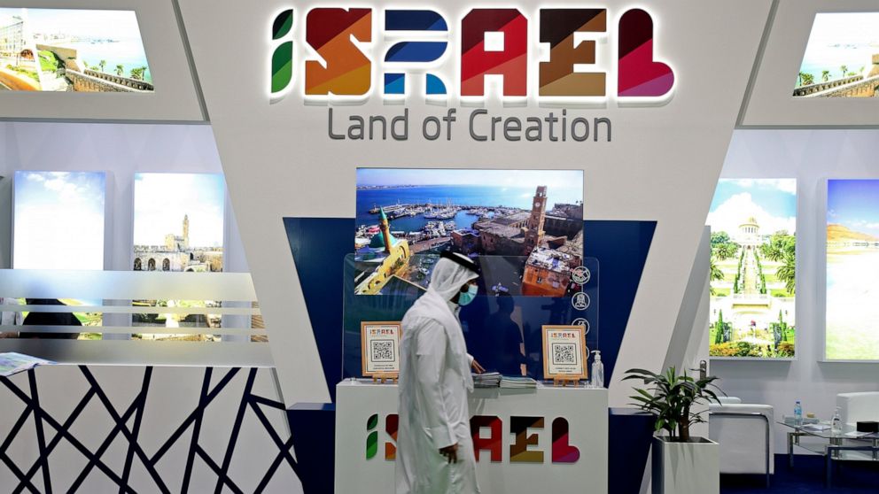 A man passes by the Israel stand on the opening day of the Arabian Travel Market exhibition, in Dubai, United Arab Emirates, Sunday, May 16, 2021. As violence flares within Israel and on a day in which Israeli airstrikes on Gaza City killed at least 