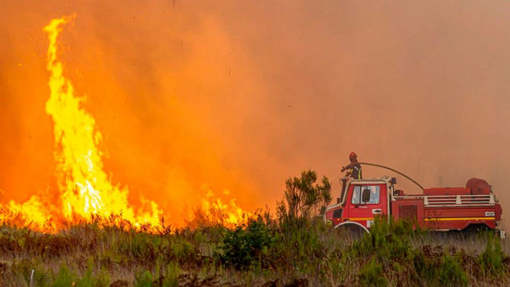 This photo provided by the SDIS33 fire brigade shows a fireman battling against a wildfire on a fire near the village of Saumos, southwestern France, Tuesday Sept.13, 2022. New wildfires raging in southwestern France have torn through over 1,000 hect