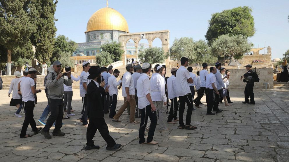 Israeli police officers escort a group of religious Jews near the Dome of the Rock Mosque in the Al Aqsa Mosque compound in Jerusalem's old city, Sunday, June 2, 2019. (AP Photo/Mahmoud Illean)