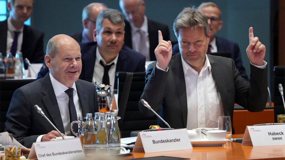 German Economy and Climate Minister Robert Habeck, front right, point up as German Chancellor Olaf Scholz, front left, opens the 'Alliance For Transformation' summit at the Chancellery in Berlin, Germany, Tuesday, June 14, 2022. (AP Photo/Michael Soh