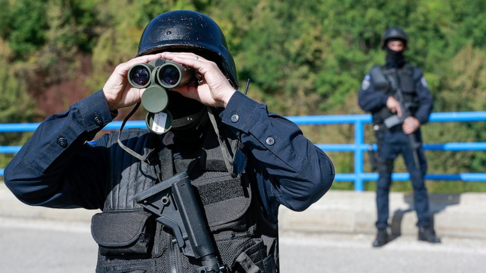 Kosovo police officers patrol the bridge over Gazivode lake near the northern Kosovo border crossing of Brnjak on the fifth day of protest on Friday, Sept. 24, 2021. Ethnic Serbs in Kosovo have been blocking the border for a fifth straight day to pro