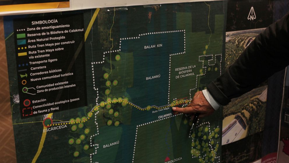 FILE - In this March 18, 2019 file photo, Rogelio Jiménez Pons, director of Fonatur, points to a map of a planned train line through the Yucatan Peninsula, during an interview in Mexico City. Mexico's President Andrés Manuel López Obrador claimed ove