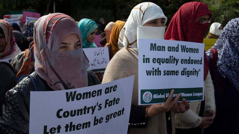 FILE - In this March 8, 2020 file photo Activists of the Pakistani religious party Minhaj-ul-Quran observe International Women's Day at a rally in Islamabad, Pakistan. An annual human rights report released this week gives Pakistan a failing grade, c