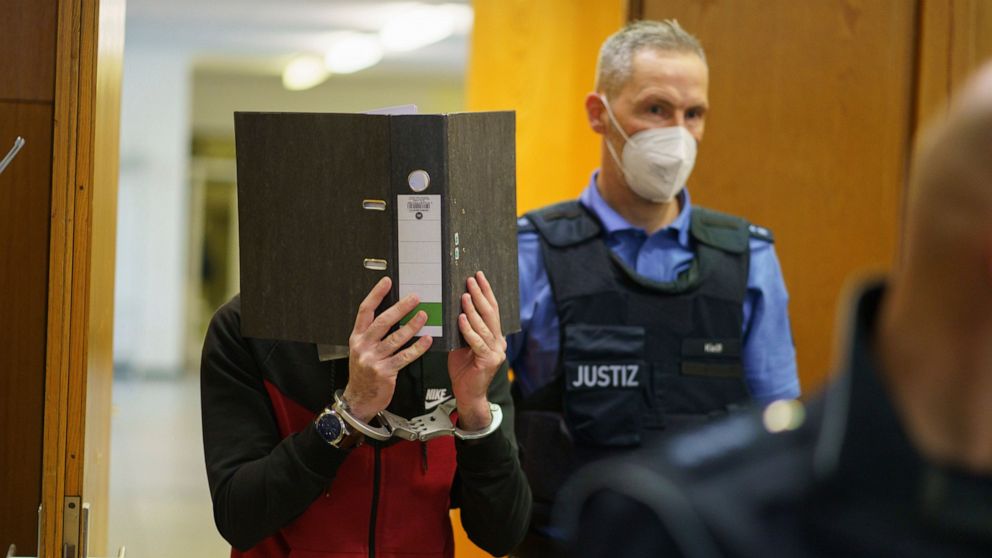 The Iraqi Taha Al-J. is led into the courtroom at Frankfurt's Higher Regional Court before the verdict is pronounced Frankfurt, Germany, Nov. 30, 2021. The Federal Prosecution accuses him of genocide, crimes against humanity, war crimes, human traffi