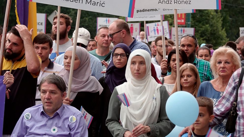 Holding banners and balloons, participants march in what they said was a gathering designed to promote traditional family values in Sarajevo, Bosnia, Saturday, Sept. 7, 2019. Several hundred people have marched in Bosnia's capital Sarajevo to express