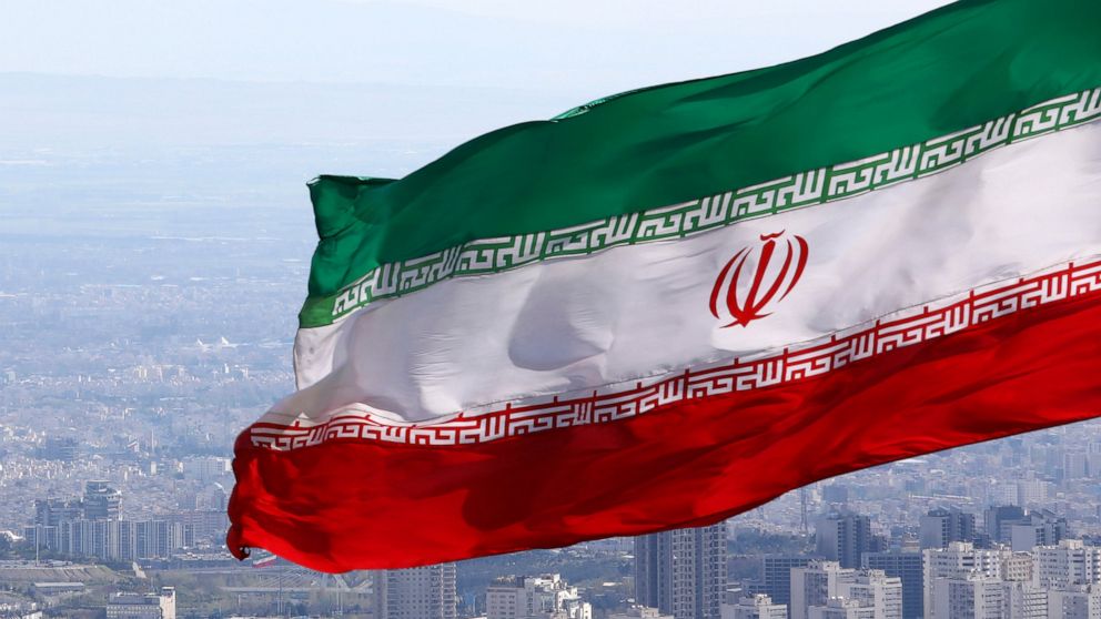 FILE - Iran's national flag waves in Tehran, Iran, March 31, 2020. Iranian media reported on Wednesday July 6, 2022, that the country’s paramilitary Revolutionary Guard has accused the deputy ambassador of the United Kingdom and other foreigners in t