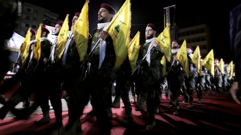 FILE - In this May 31, 2019 file photo, Hezbollah fighters march at a rally to mark Jerusalem day or Al-Quds day, in the southern Beirut suburb of Dahiyeh, Lebanon. On Monday, Oct. 18, 2021, Hezbollah leader Sheik Hassan Nasrallah revealed that his m