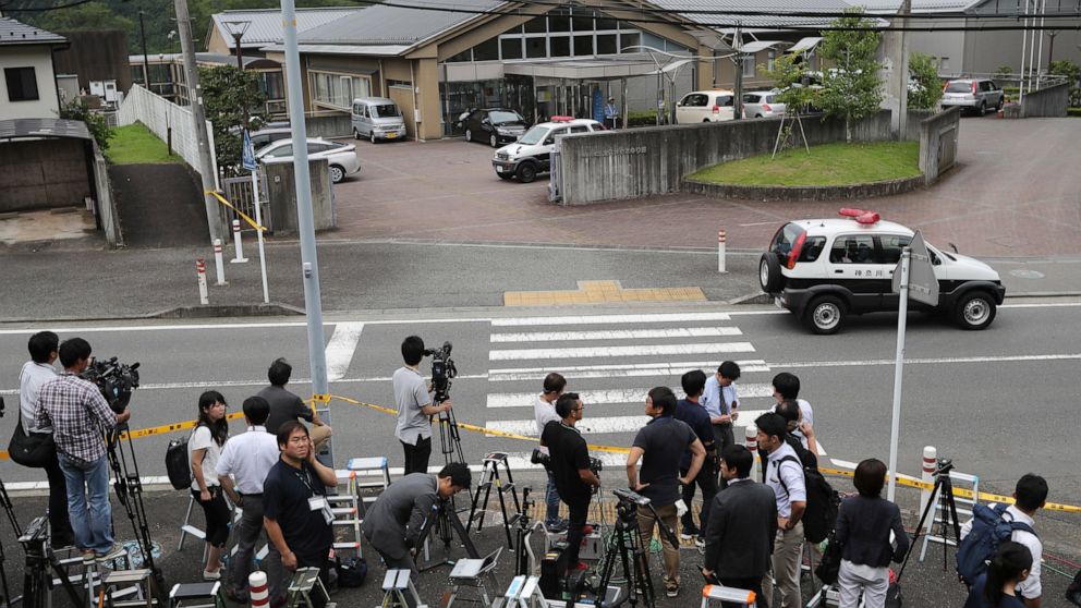 FILE - In this July 26, 2016, file photo, journalists gather in front of Tsukui Yamayuri-en, a facility for the handicapped where a former care home employee killed disabled people, in Sagamihara, outside Tokyo. The Yokohama District Court sentenced 