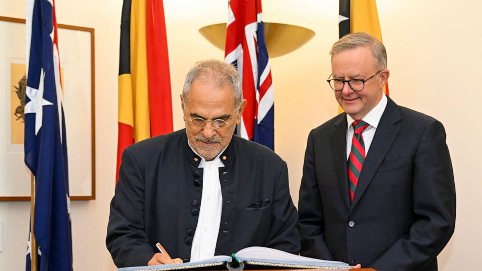 East Timorese President Jose Ramos-Horta, left, signs the visitors book as Australian Prime Minister Anthony Albanese watches ahead of a bilateral meeting at Parliament House in Canberra, Australia, Wednesday, Sept. 7, 2022. Ramos-Horta is on an offi