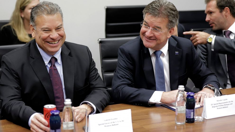 U.S. Deputy Assistant Secretary Gabriel Escobar, left, and European Union envoy Miroslav Lajcak react, during talks on normalizing relations between Serbia and Kosovo, in northern, Serb-dominated part of ethnically divided town of Mitrovica, Kosovo, 