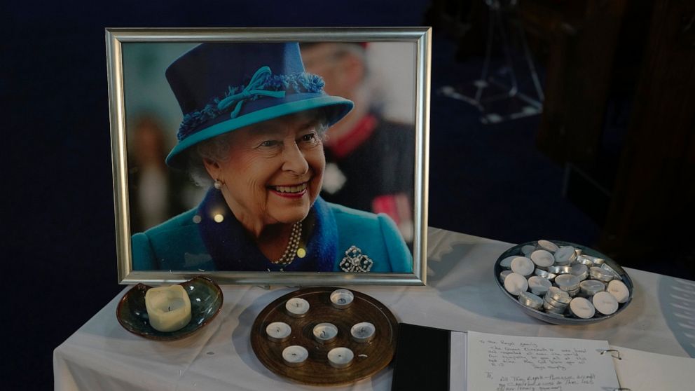 A book of condolence and photo of Queen Elizabeth II are displayed at a church in the district of Southall in London, Tuesday, Sept. 13, 2022. In a church in a West London district known locally as Little India, a book of condolence for Queen Elizabe