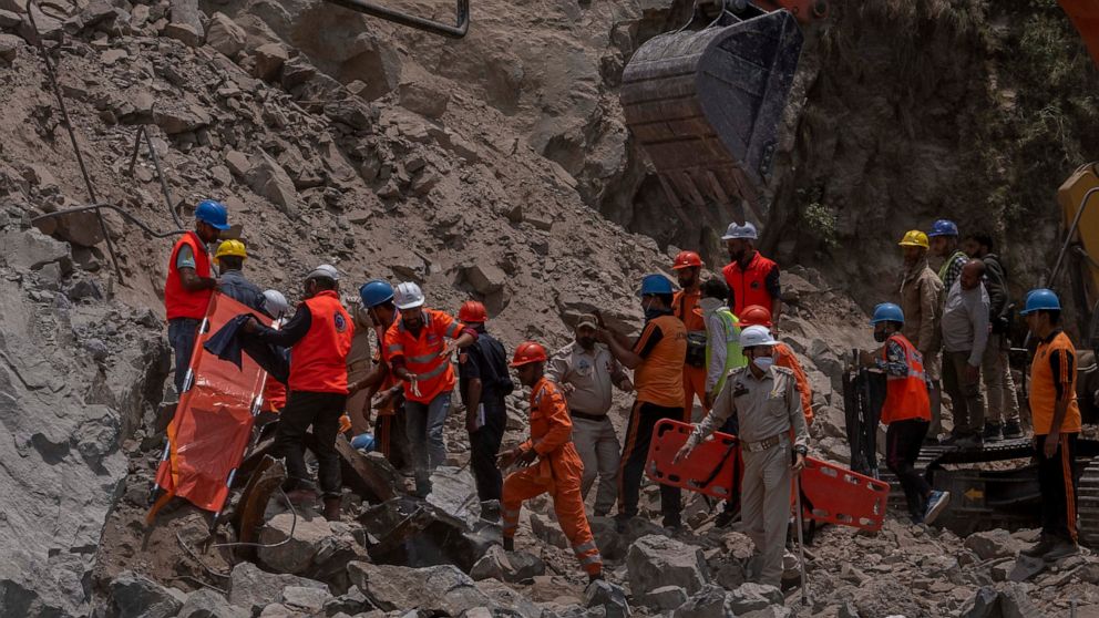 Rescue workers prepare to retrieve the body of a victim at the site of a collapsed tunnel in Ramban district, south of Srinagar, Indian controlled Kashmir, Friday, May 20, 2022. An official in Indian-controlled Kashmir said Friday that 10 workers wer